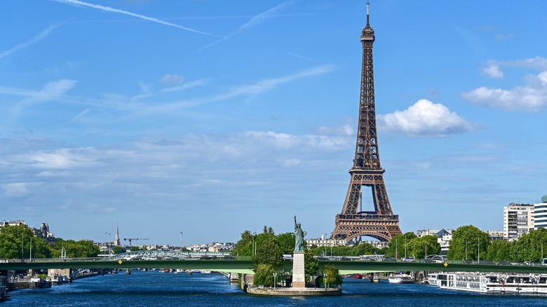 Statue of Liberty replica on the Seine River dwarfed by Eiffel Tower