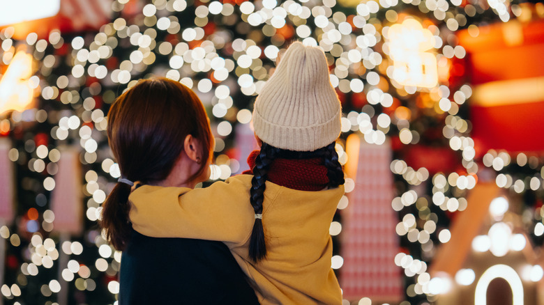 A woman and young girl in the holiday season winter wonderland