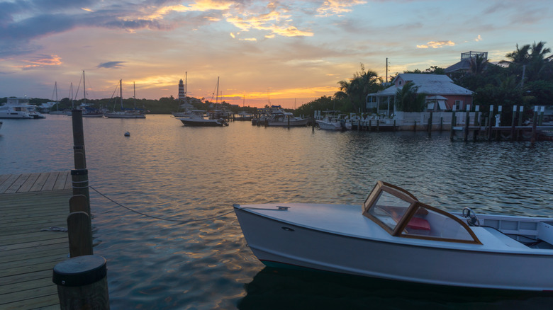 Cottages and boats in the harbor at sunset, Hope Town, Bahamas