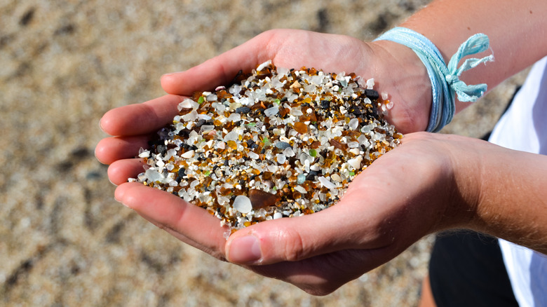 Hands holding some glass found on Glass Beach