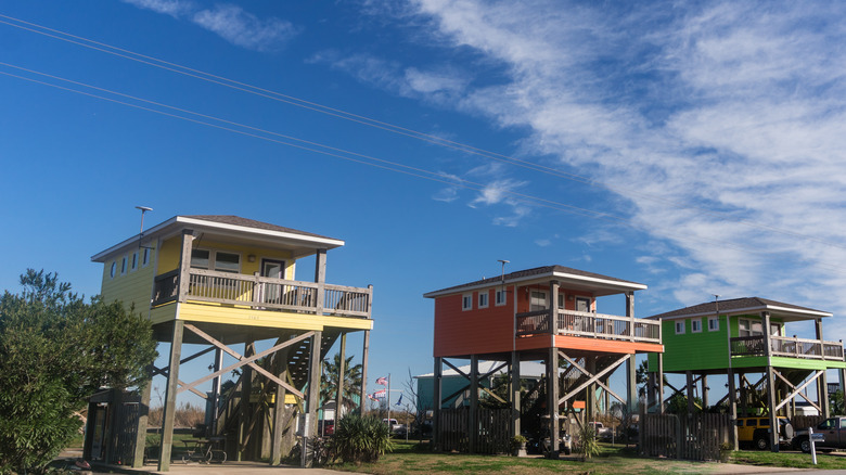 Row of colorful houses built on the coast of Holly Beach, LA