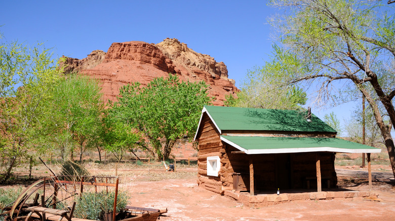 An old building and cliffs at Lonely Dell Ranch Historic Area