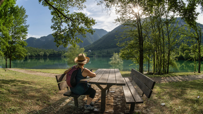 A woman looking out at the water on Lago di Tenno in northern Italy