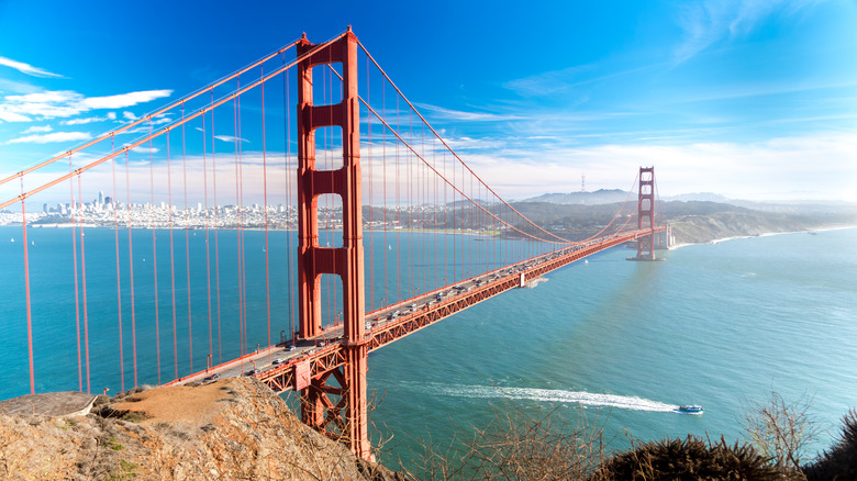 Golden Gate Bridge with boat passing in daylight