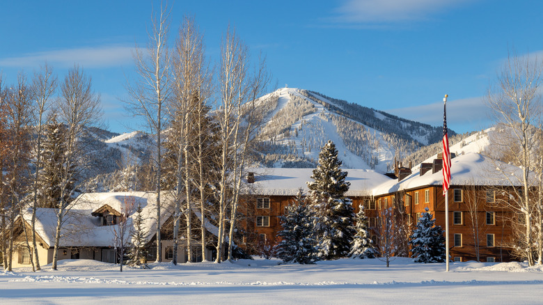 A snow-covered Sun Valley Lodge in front of Mt. Baldy in the winter in Idaho