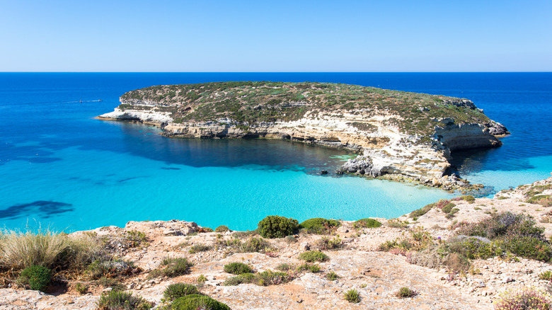 Isola dei Conigli surrounded by blue water in Lampedusa, Italy