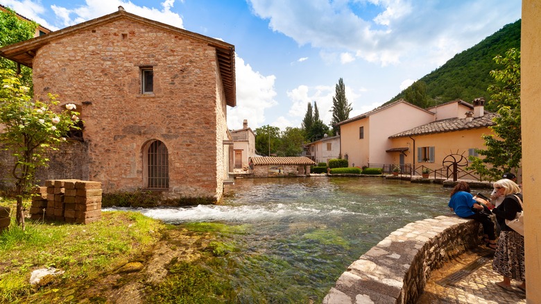 People standing near a waterway in Rasiglia, near Perugia, Italy