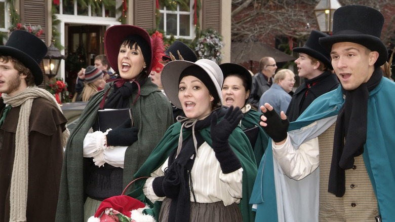 Carolers in historical dress in Saint Charles, Missouri during the Christmas season