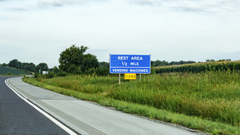 A sign alongside the road saying rest area closed