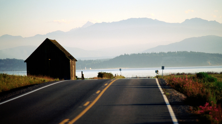 A road on Whidbey Island with a small house and views of the Puget Sound