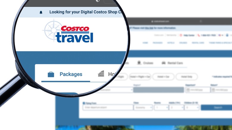 A magnifying glass focused on the Costco Travel website