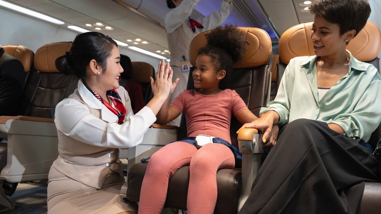 Flight attendant greeting child