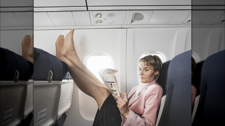 Woman with feet on airplane