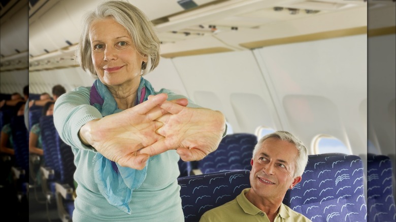 Woman stretching in aisle