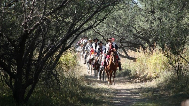 historic reenactors riding horses