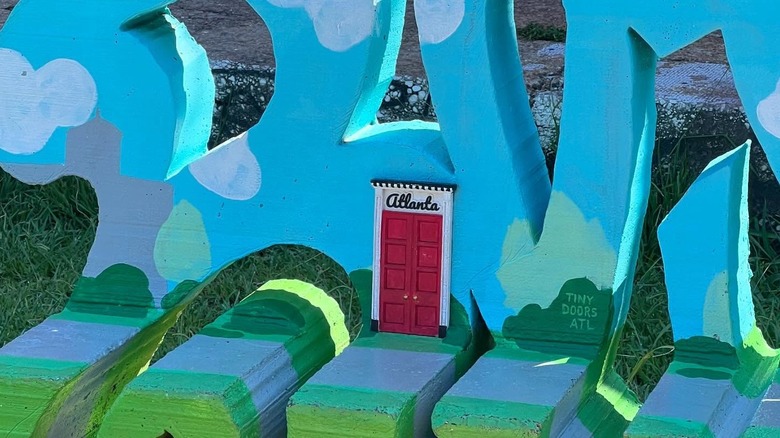 Tiny red door on a painted bench in Atlanta