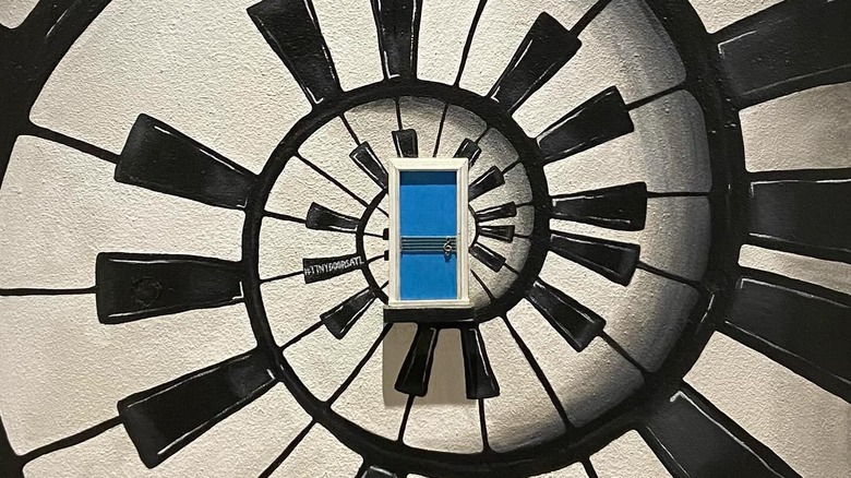 Tiny blue door built into a spiral piano mural in Atlanta