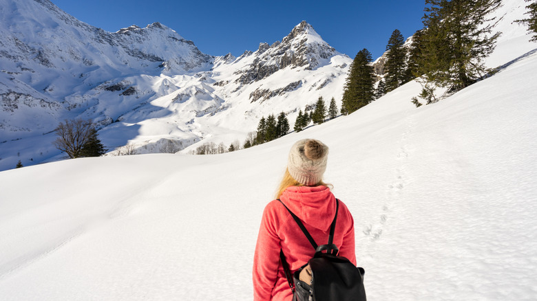 A woman snowshoeing in the Swiss Alps