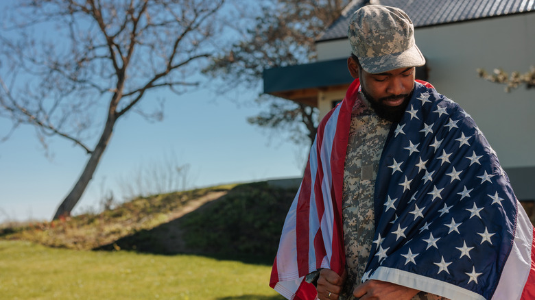 Solider wrapped in American flag
