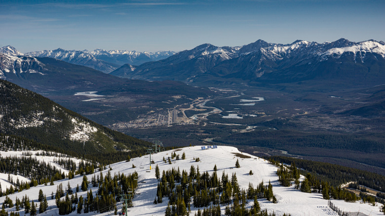 looking over a Canadian valley with the town of Jasper framed by the Marmot Basin Ski Resort slope