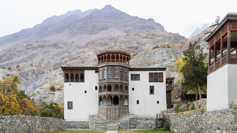 the 19th century khaplu Palace with a large mountain behind it