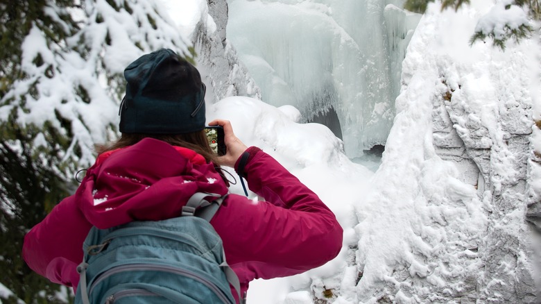 hiker photographs ice 