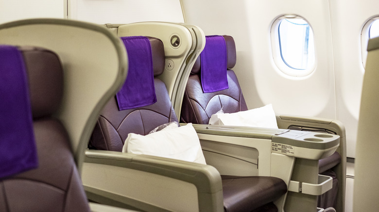 Business Class seats on an airplace next to a window