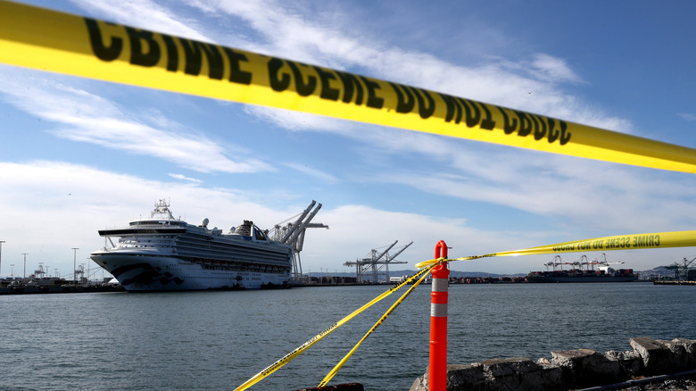 Crime tape with a cruise ship in the background