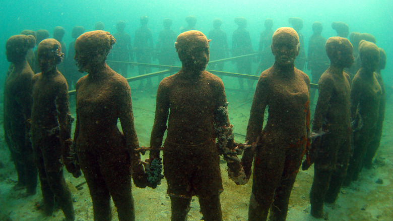 sculptures of people underwater