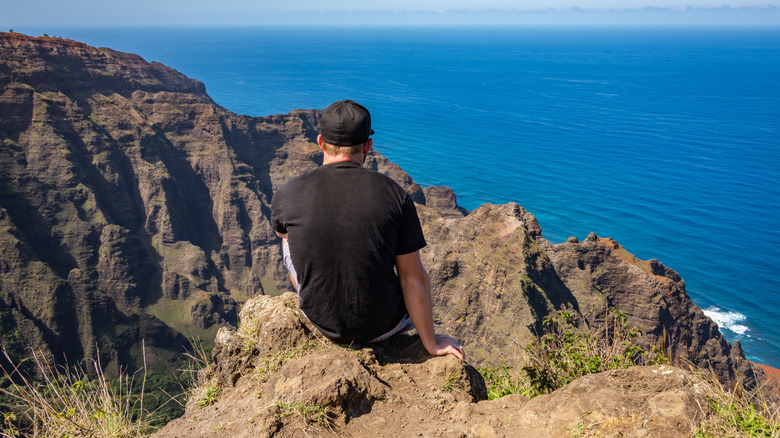 man sitting cliffside