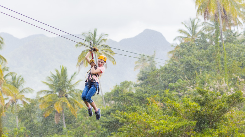 woman ziplining in rain