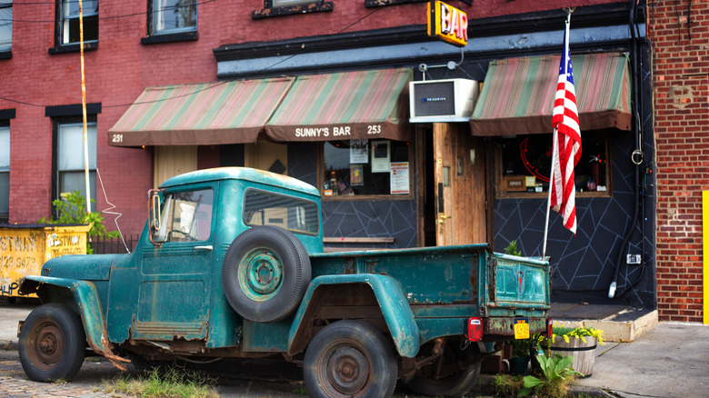 An antique pickup truck parked in front of Sunny's Bar in Red Hook, Brooklyn