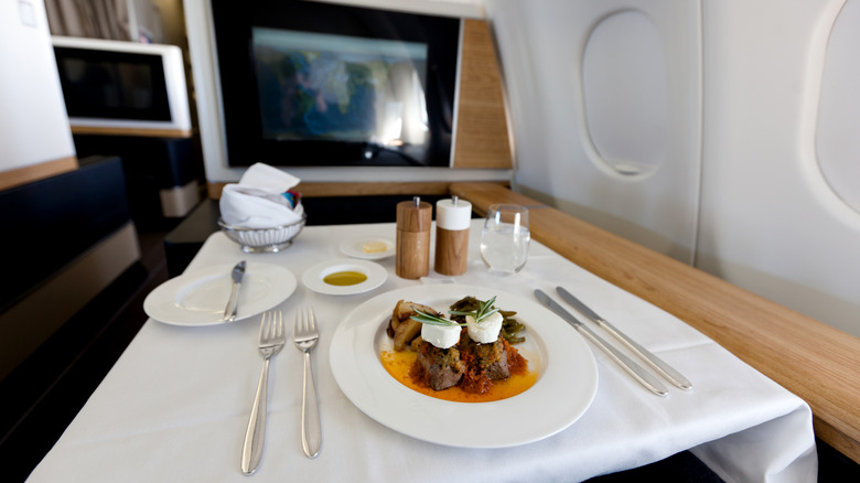 First-class in-flight dining of plated meal and white linen