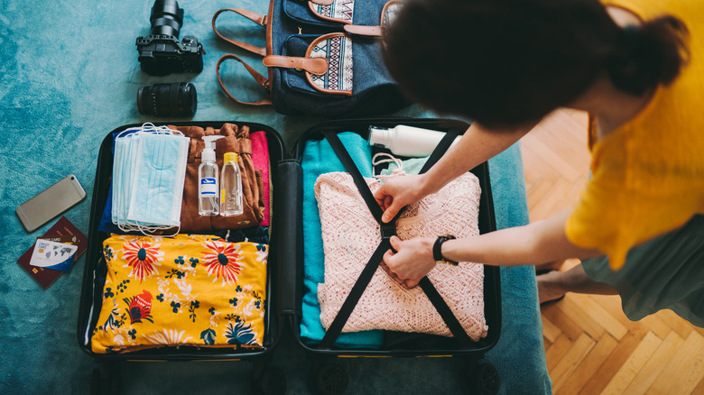 Woman packing organized suitcase