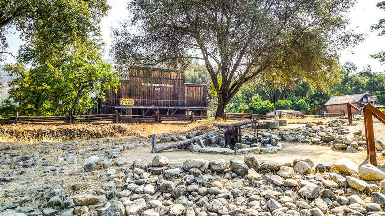 An old building and stones surrounded by trees
