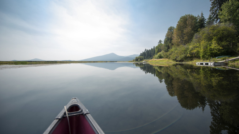 Canoe on lake with mountain backdrop