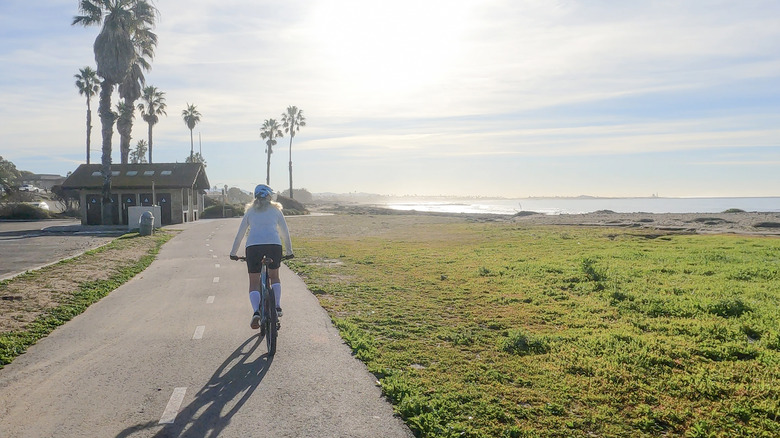 Woman biking along the Ventura boardwalk
