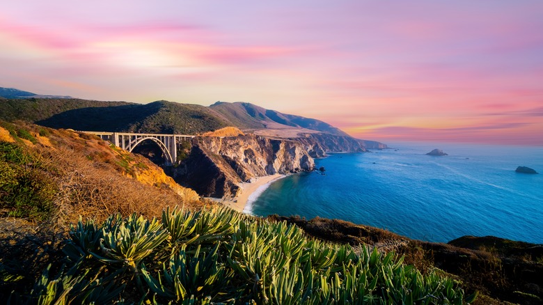 Some of the California coastline with a pink sky