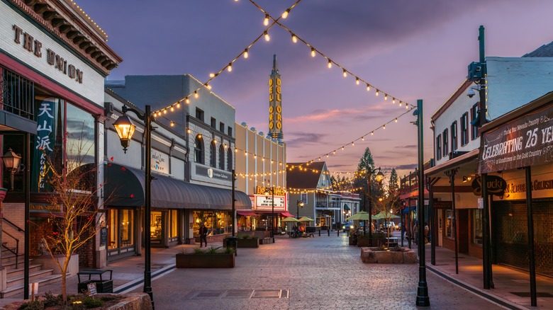 A street of businesses and string lights at sundown in Grass Valley