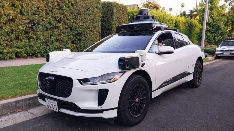 Driverless Waymo Jaguar I-PACE car on a residential street