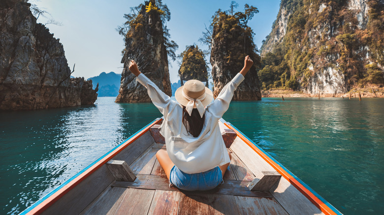 A woman riding a long tail boat