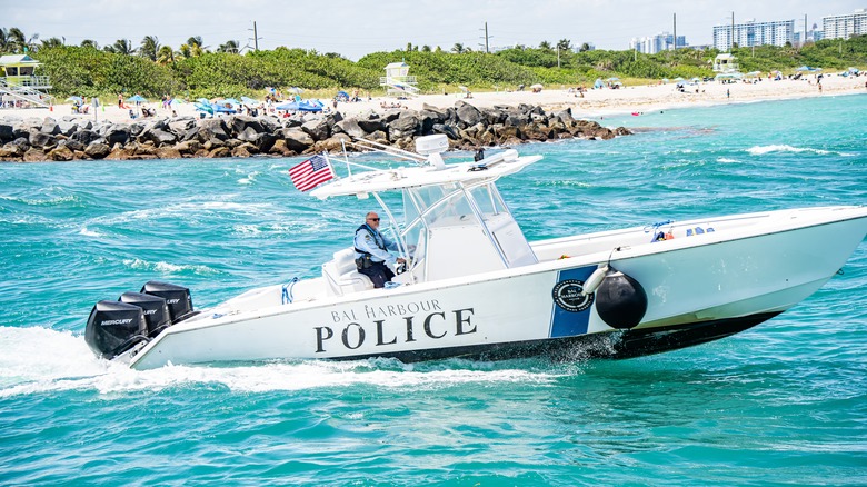 A police officer riding a boat