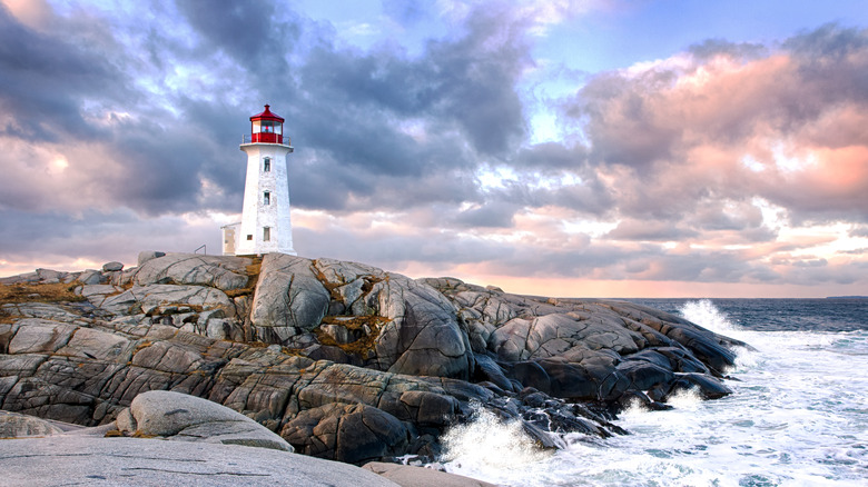 Peggy's Cove Lighthouse on rocks with crashing waves