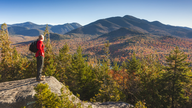 A lone hiker high in the Adirondack mountains in New York during the fall