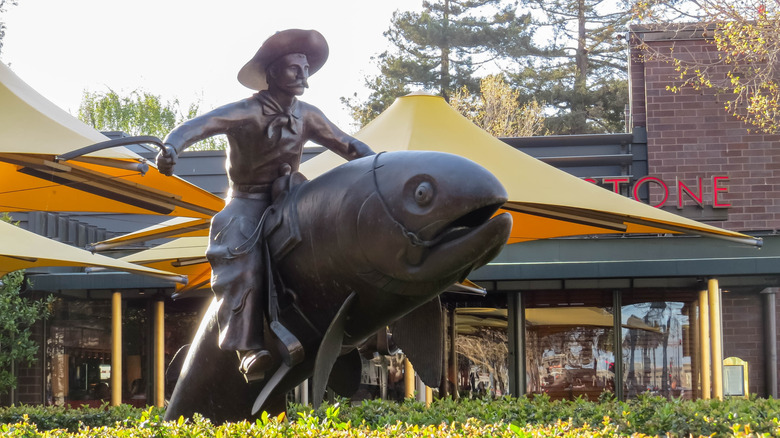 Statute of cowboy riding a fish by LC Shank in front of a Hillstone in San Francisco