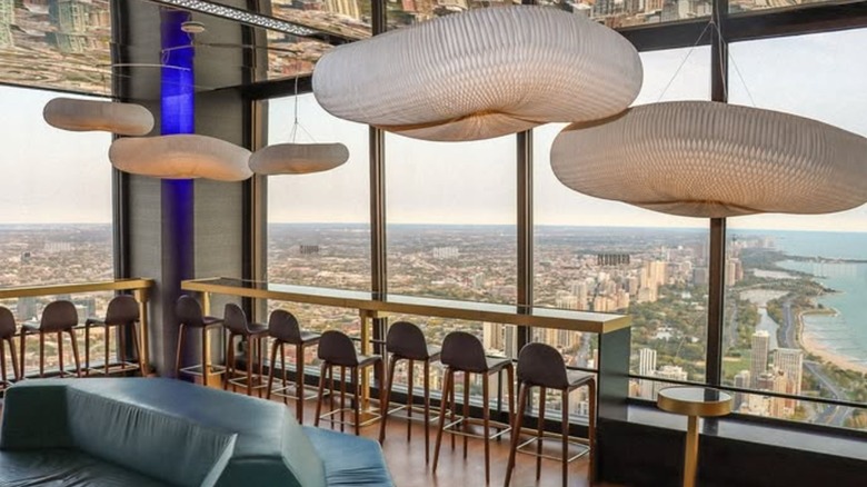 The inside of CloudBar, featuring stools and white overhanging decor