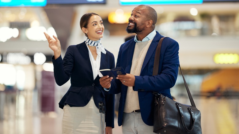 An airport employee assisting a passenger