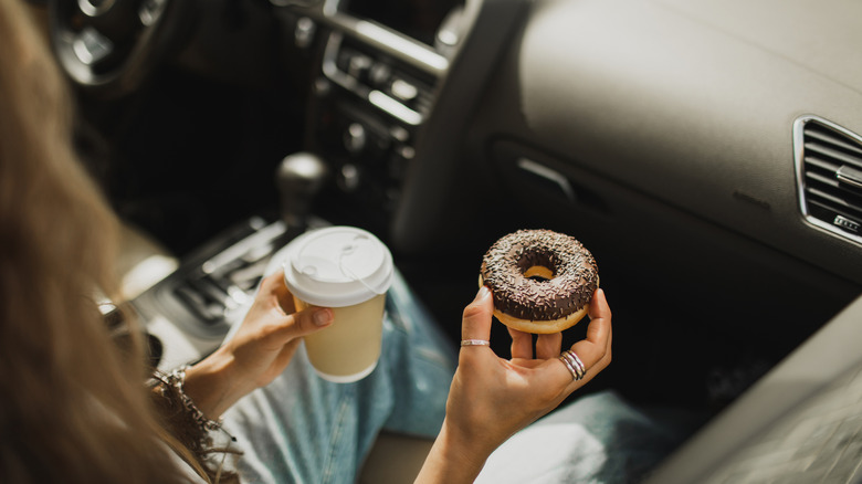 Passenger with coffee and a doughnut