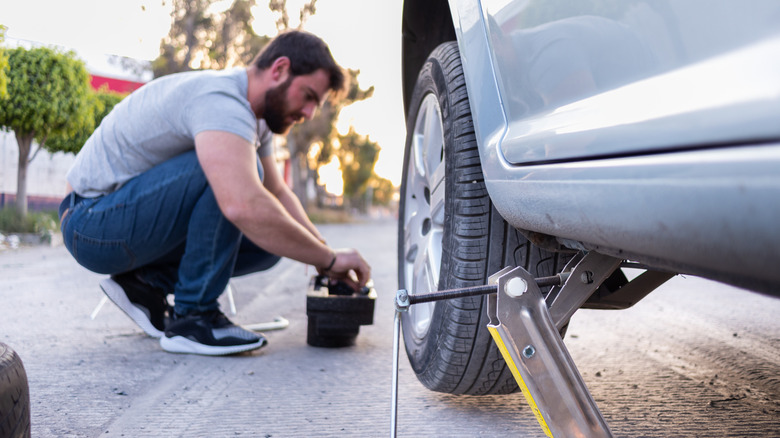 Man changing flat tire