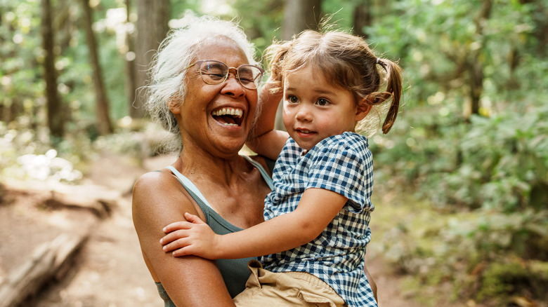 Older woman carrying a child